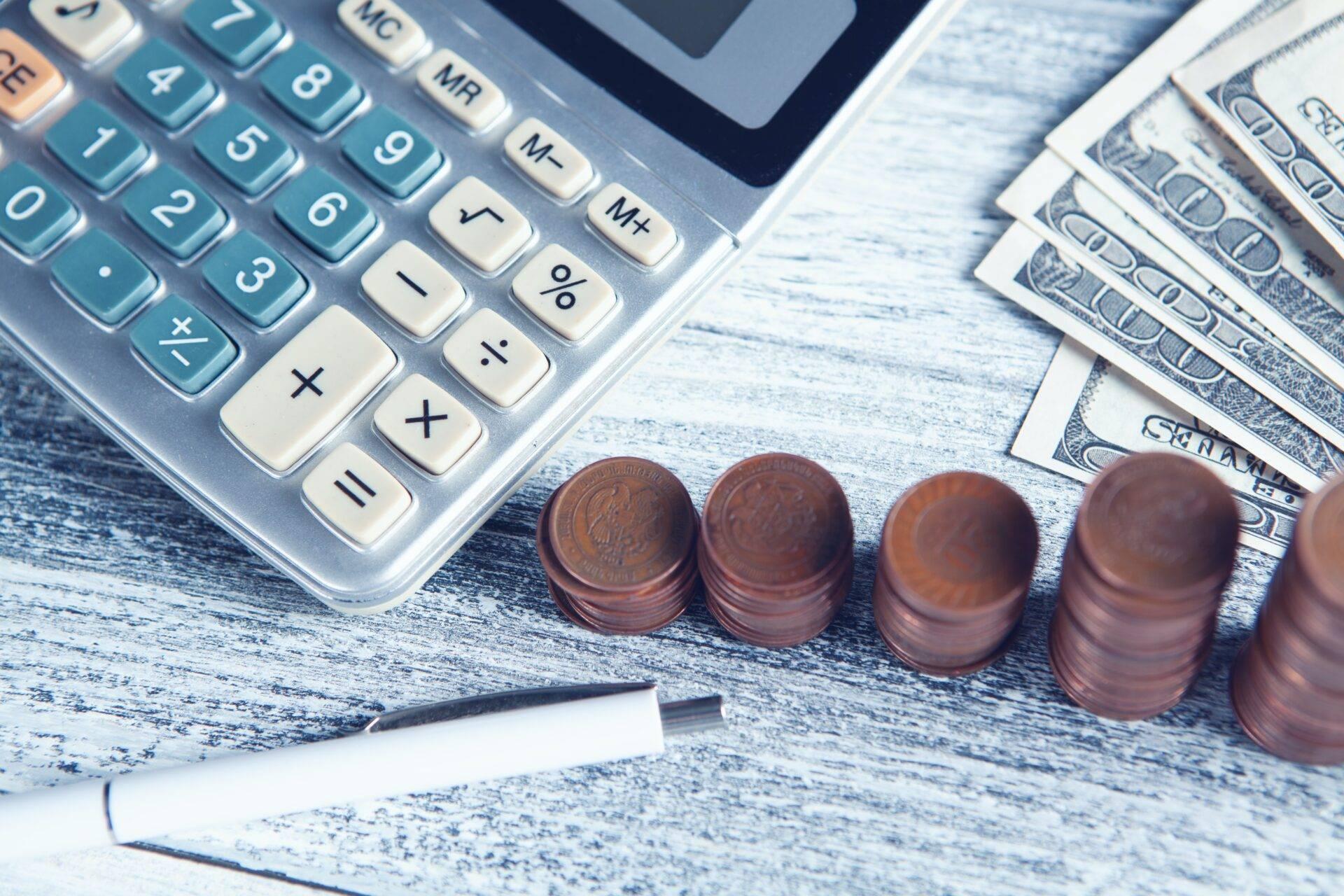 Piggy bank and budget notebook on a table, illustrating savings preparation for a round-the-world trip