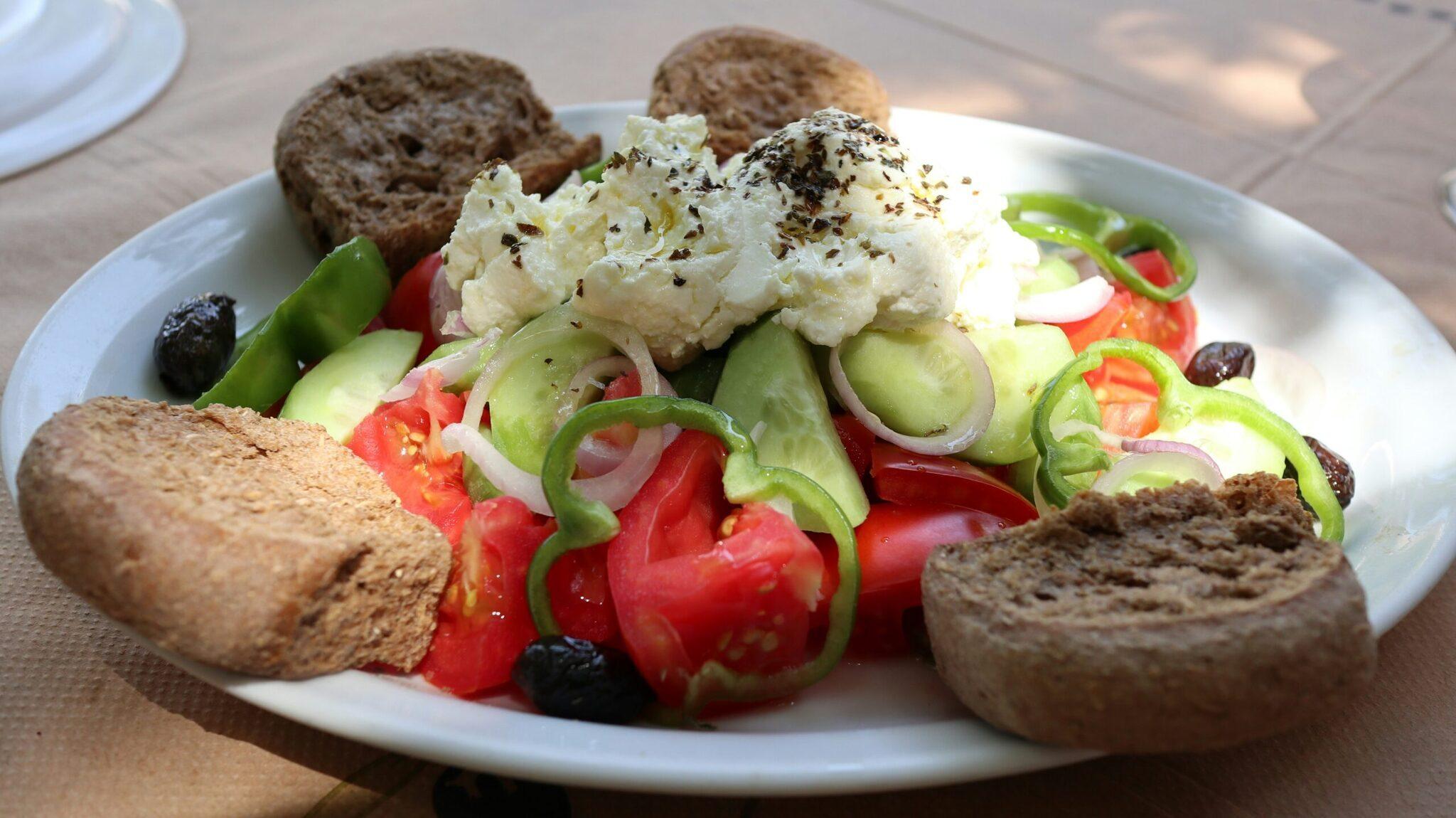 Assiette de mezze méditerranéenne avec houmous, pain complet, concombre, tomate et olives noires