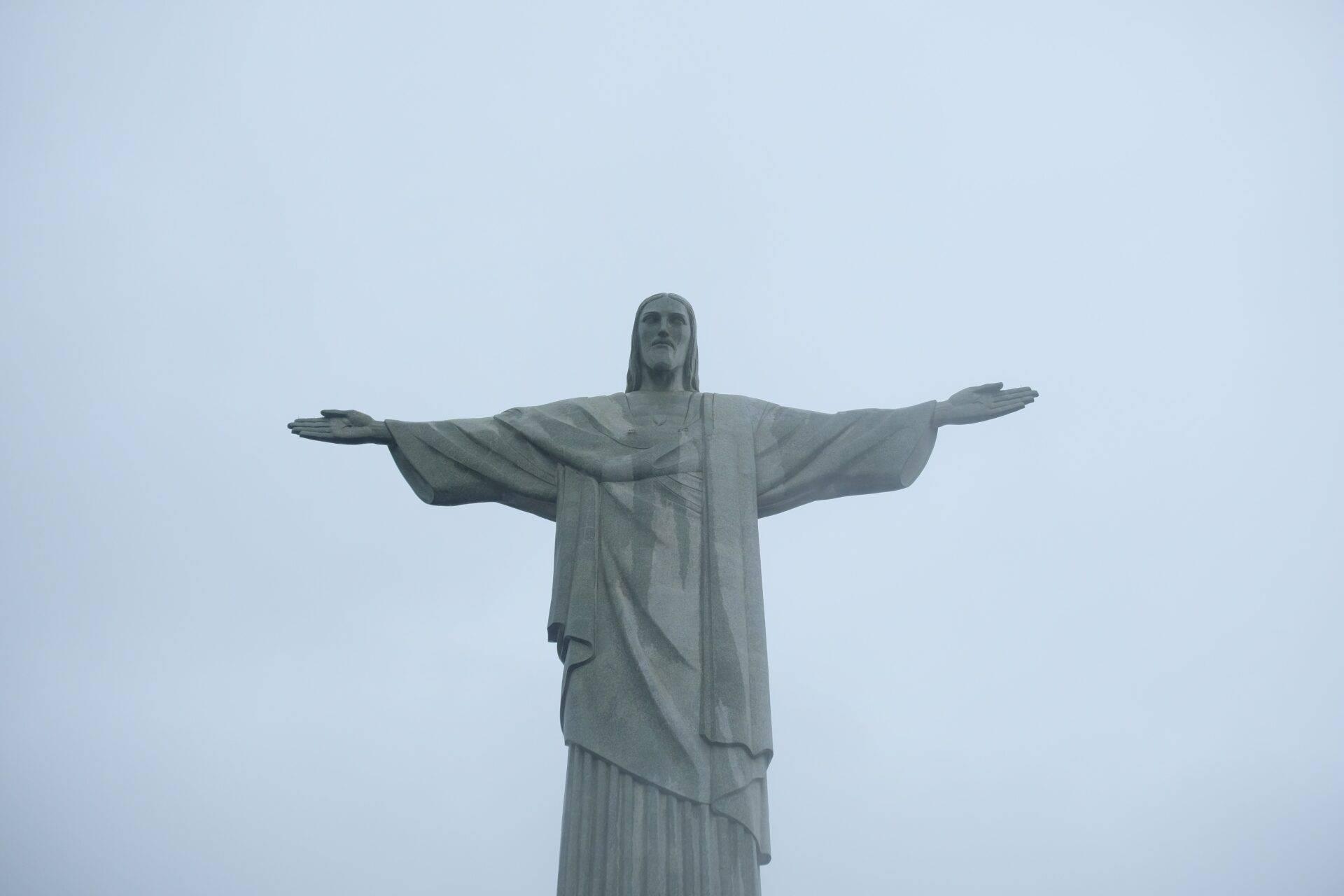 Towering statue with outstretched arms dominating a vast open landscape, Brazil’s most iconic monument