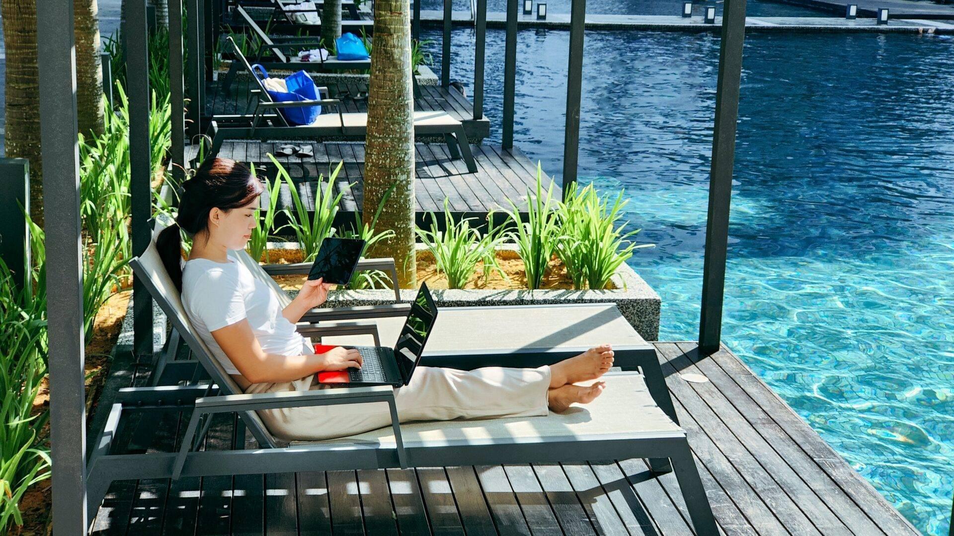 Traveller working on a laptop in a café abroad during a round-the-world trip