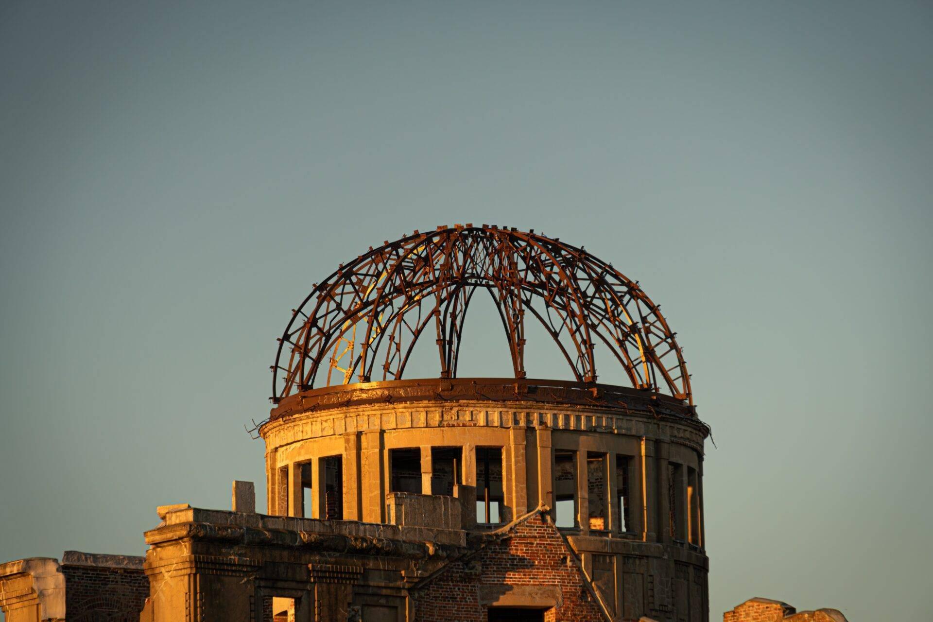 Ruins of the memorial dome with its distinctive metal framework against a clear sky, a historic architectural symbol